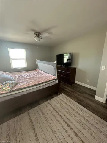 Bedroom featuring ceiling fan and wood finished floors