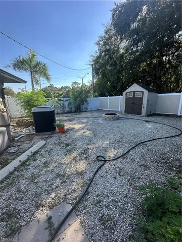 Fenced backyard with a storage unit