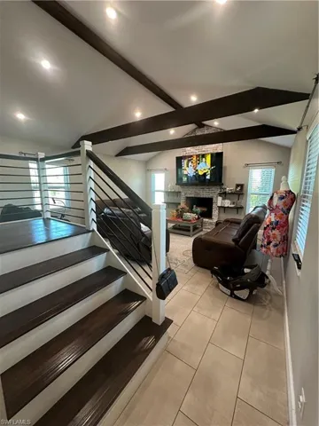 Staircase with a fireplace and tile patterned floors