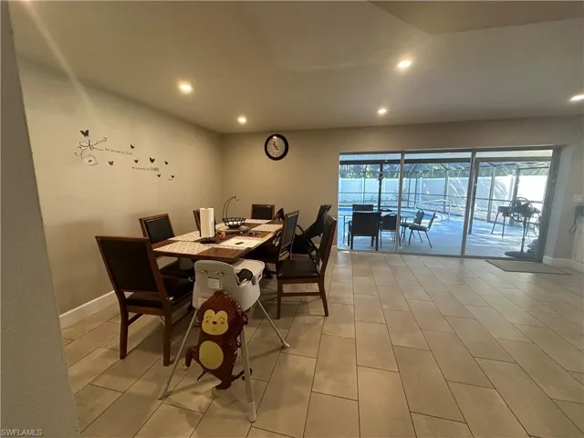 Dining area with recessed lighting and a sunroom