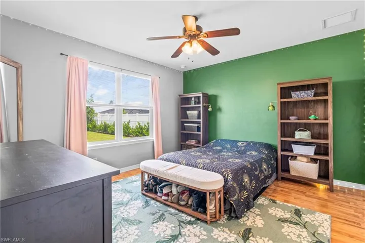 Bedroom with light wood-style floors and ceiling fan