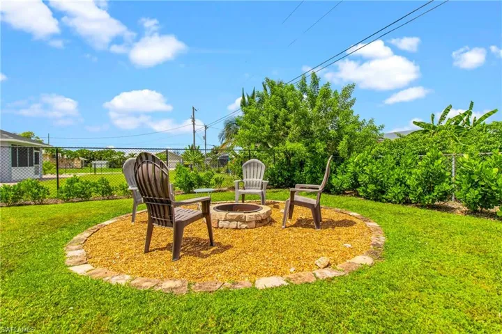 View of yard with a fire pit and a patio area