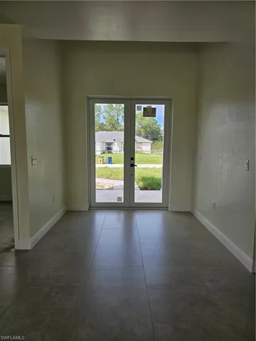 Unfurnished room featuring french doors