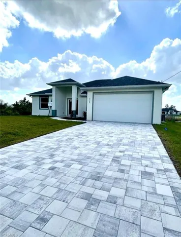 View of front of home featuring a garage and a front lawn