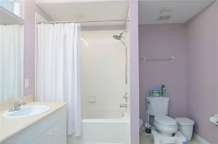 Bathroom featuring vanity and shower / tub combo with curtain