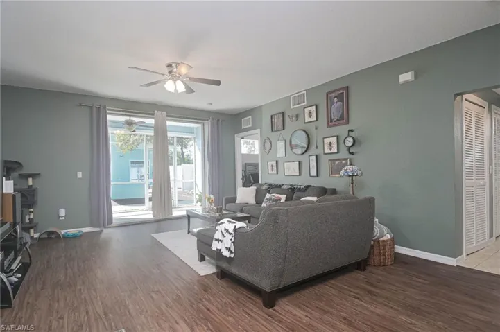 Living area featuring wood finished floors and a ceiling fan
