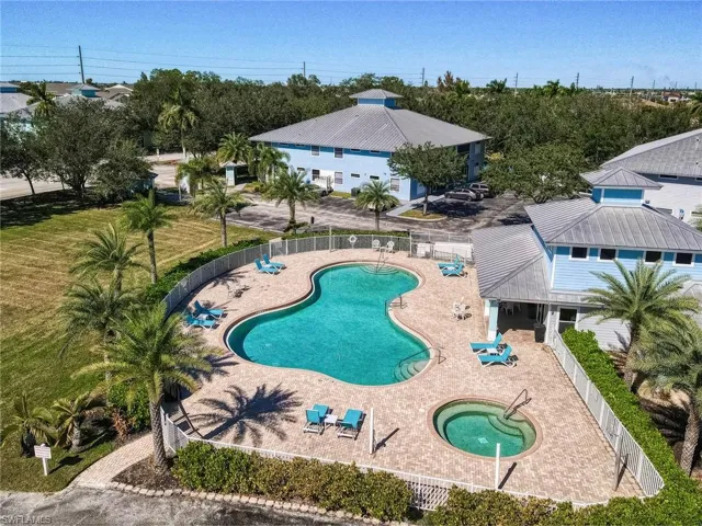 Community pool with a community hot tub and a patio