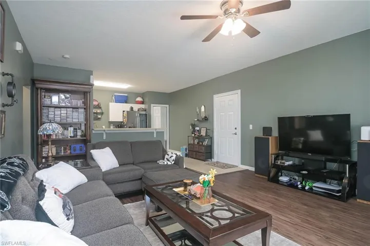 Living area featuring wood finished floors and ceiling fan