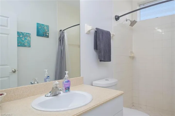 Bathroom featuring a shower stall and vanity