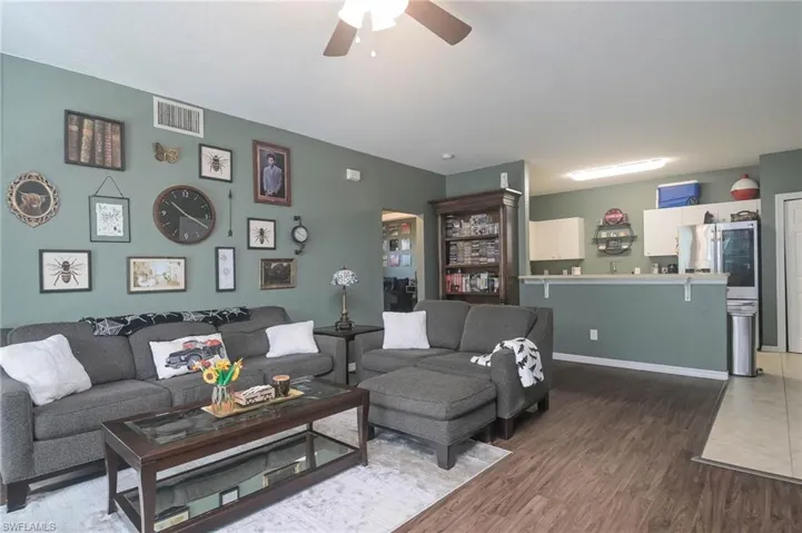 Living area with wood finished floors and a ceiling fan