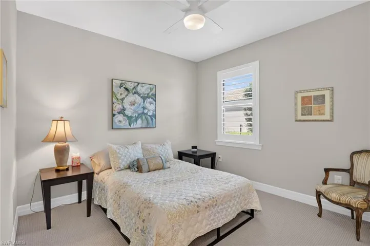Carpeted bedroom featuring baseboards and a ceiling fan