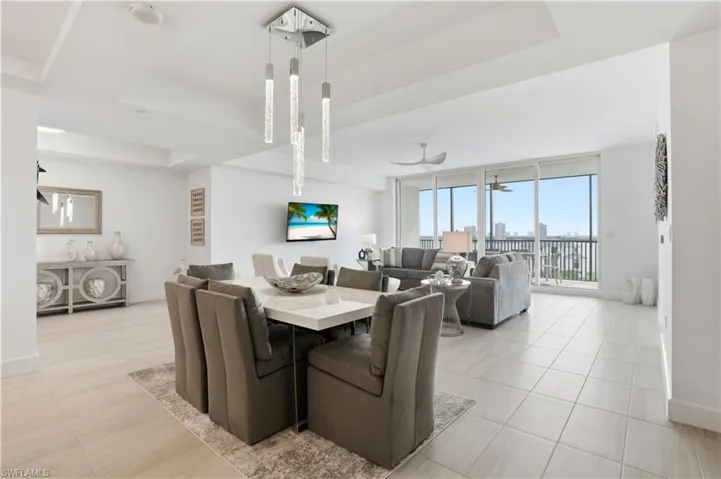 Dining area with breathtaking views of the beautiful Fort Myers beach out of your sliding  impact glass doors. Virtually edited