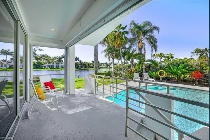 Outdoor pool featuring a patio and a water view