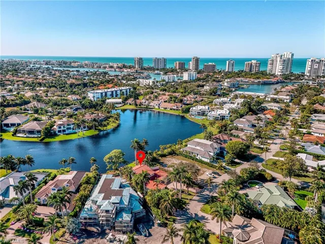 Aerial view of residential area featuring a large body of water