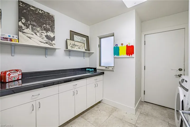 Laundry area with cabinet space and washing machine and dryer