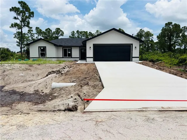 Contemporary single-story residence featuring a dark asphalt shingle roof and a smooth stucco exterior