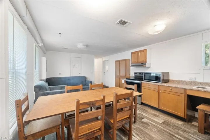 Dining area featuring light wood-style flooring and a textured ceiling