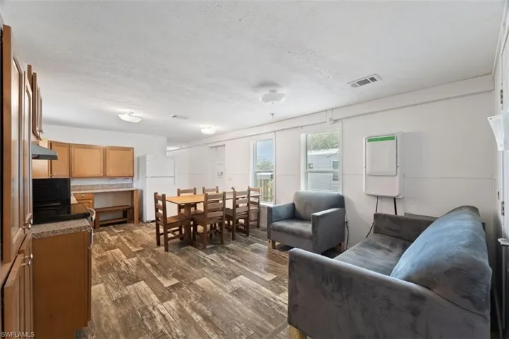 Living area with dark wood finished floors and a textured ceiling