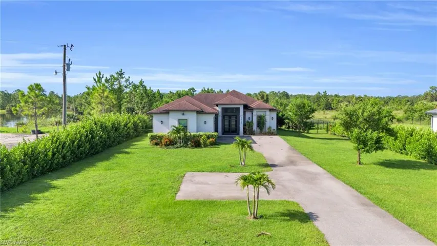 Mediterranean / spanish-style house featuring a front yard