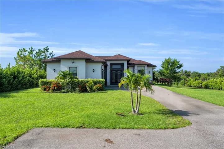 Mediterranean / spanish home with a front yard