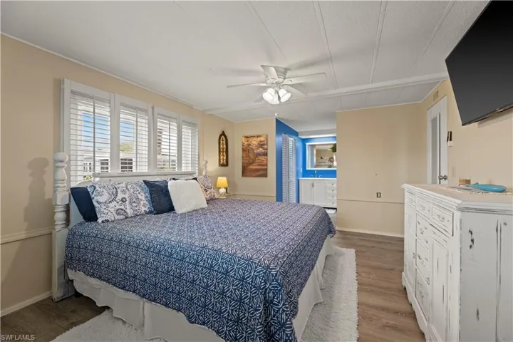 Bedroom featuring ceiling fan and hardwood / wood-style flooring