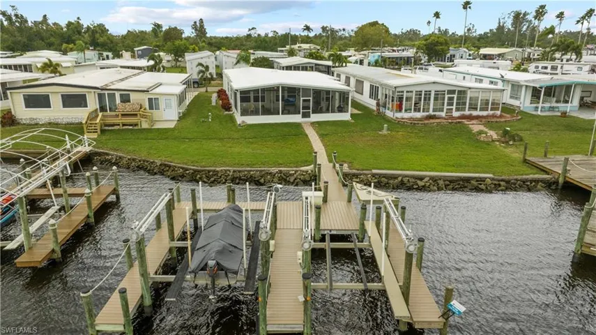 Dock area with a yard and a water view