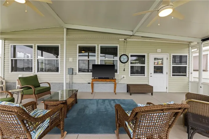 Sunroom / solarium featuring ceiling fan and vaulted ceiling