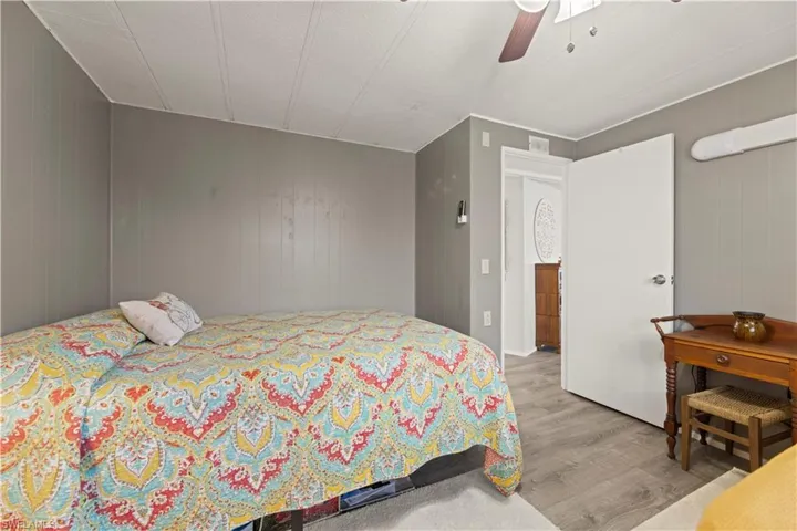 Bedroom with ceiling fan and hardwood / wood-style flooring