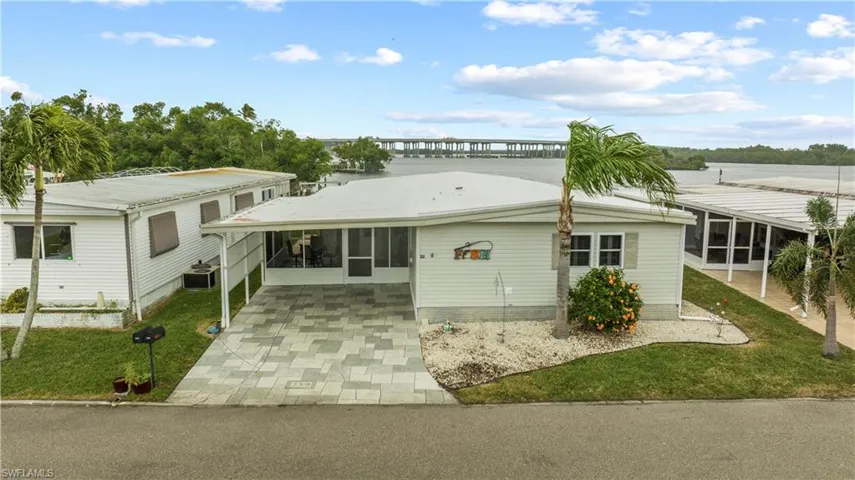 View of front of home with a sunroom and a carport