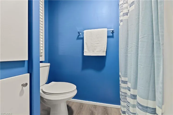Bathroom featuring toilet and wood-type flooring