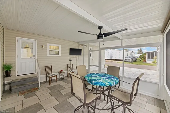 Sunroom with beamed ceiling and ceiling fan