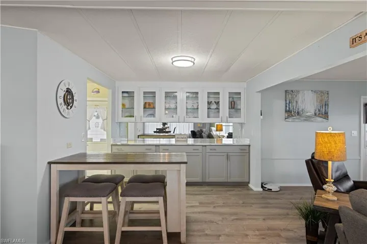 Kitchen with a kitchen breakfast bar and vinyl flooring