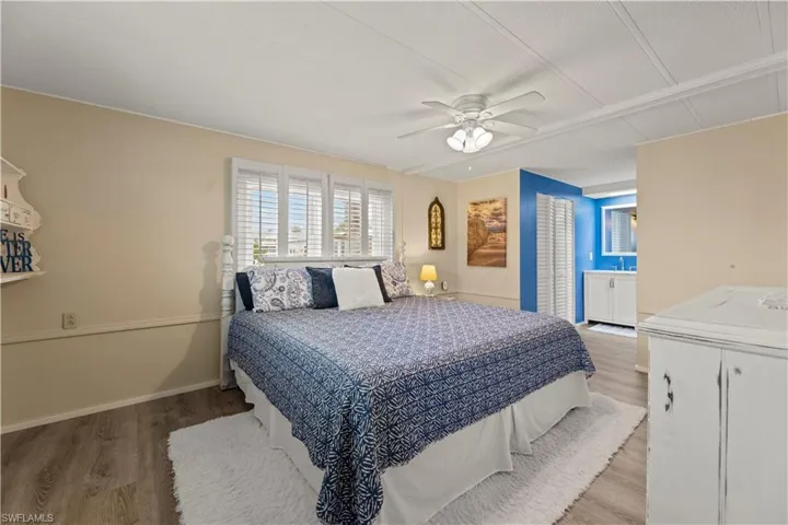 Master Bedroom with ceiling fan and light vinyl / wood-style flooring