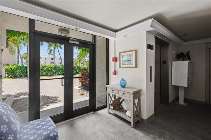 Entryway featuring french doors, crown molding, and elevator