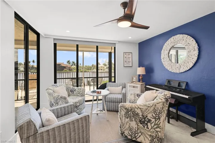 Sun room with ceiling fan and expansive windows