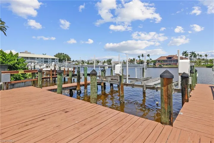 Dock area with boat lift and a water view
