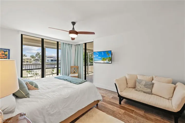 Master Bedroom suite  #2 featuring access to outside, light wood-style flooring, a ceiling fan, and floor to ceiling windows
