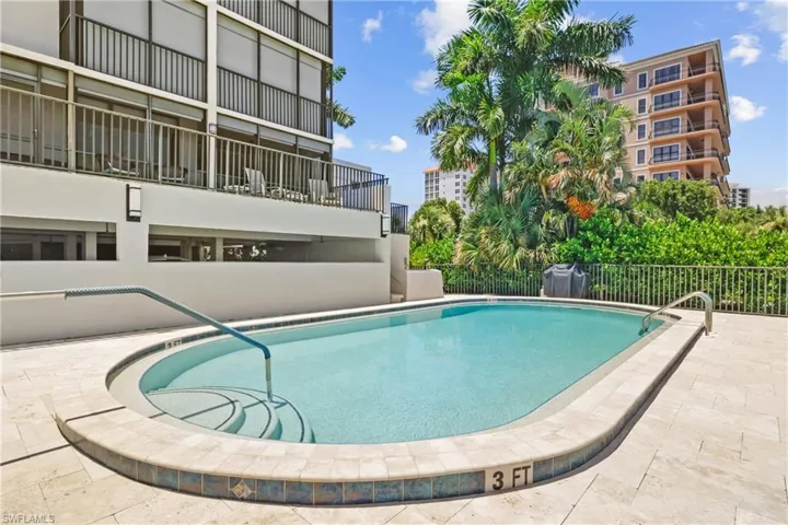 Community pool featuring a patio