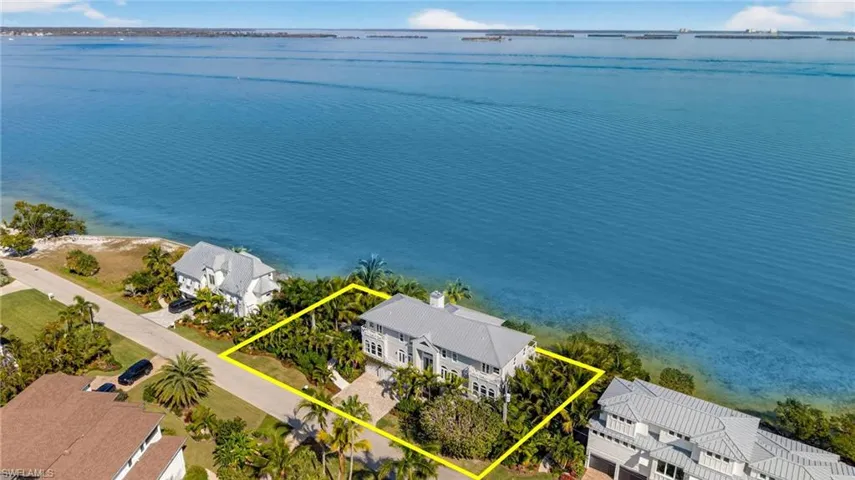 Aerial view of property's location with property boundaries highlighted and a large body of water