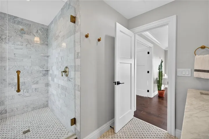 Bathroom featuring a shower stall and vanity