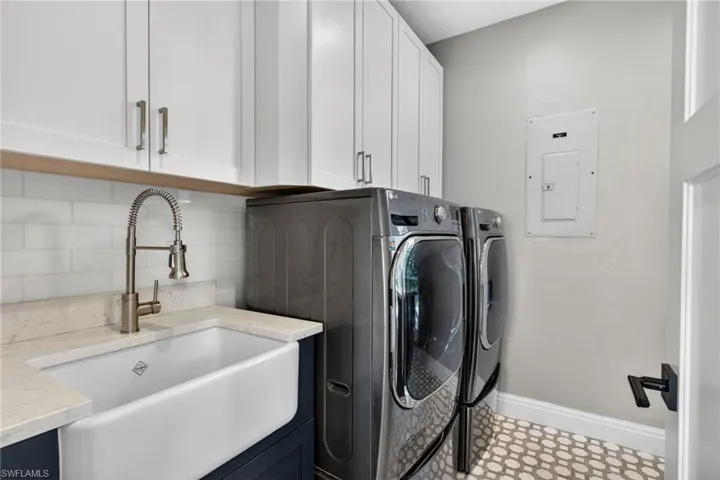 Laundry area with independent washer and dryer and electric panel