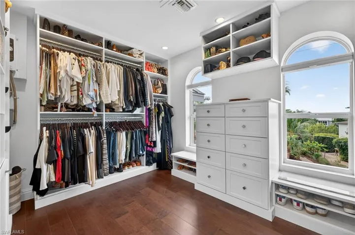 Walk in closet featuring dark wood-style flooring