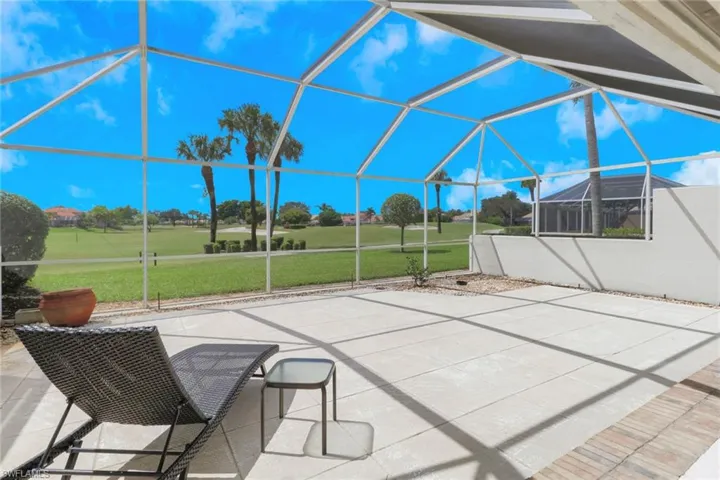 View of patio with a sunroom and glass enclosure