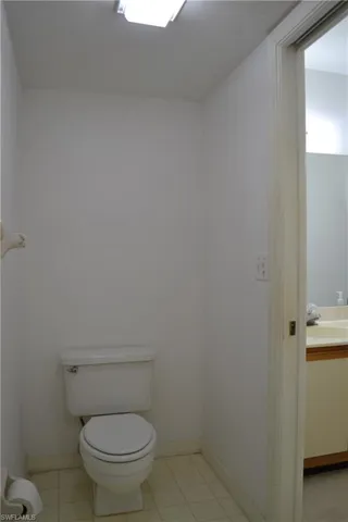Half bathroom with vanity and tile patterned floors