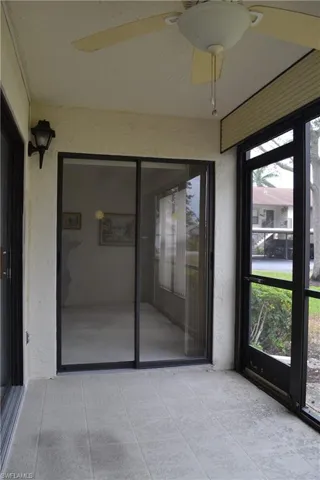 Unfurnished sunroom featuring a ceiling fan