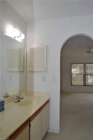 Bathroom with double vanity and ceiling fan