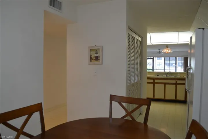 Dining space with light floors and a chandelier