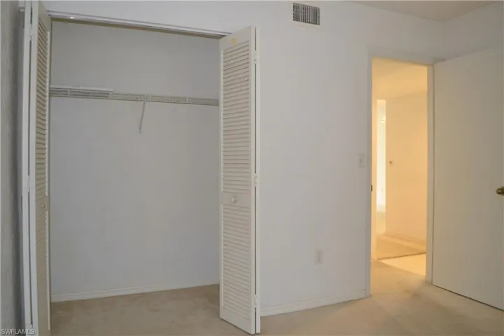Unfurnished bedroom featuring a closet and carpet flooring