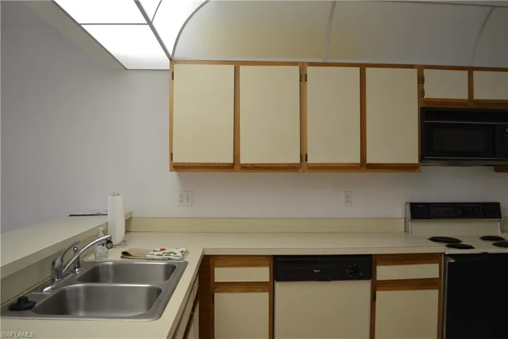 Kitchen featuring white appliances and light countertops
