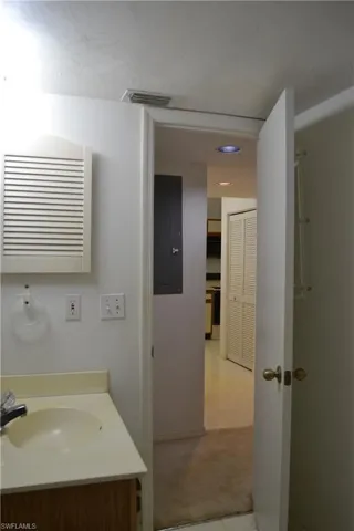 Bathroom featuring vanity, tile patterned floors, electric panel, and recessed lighting